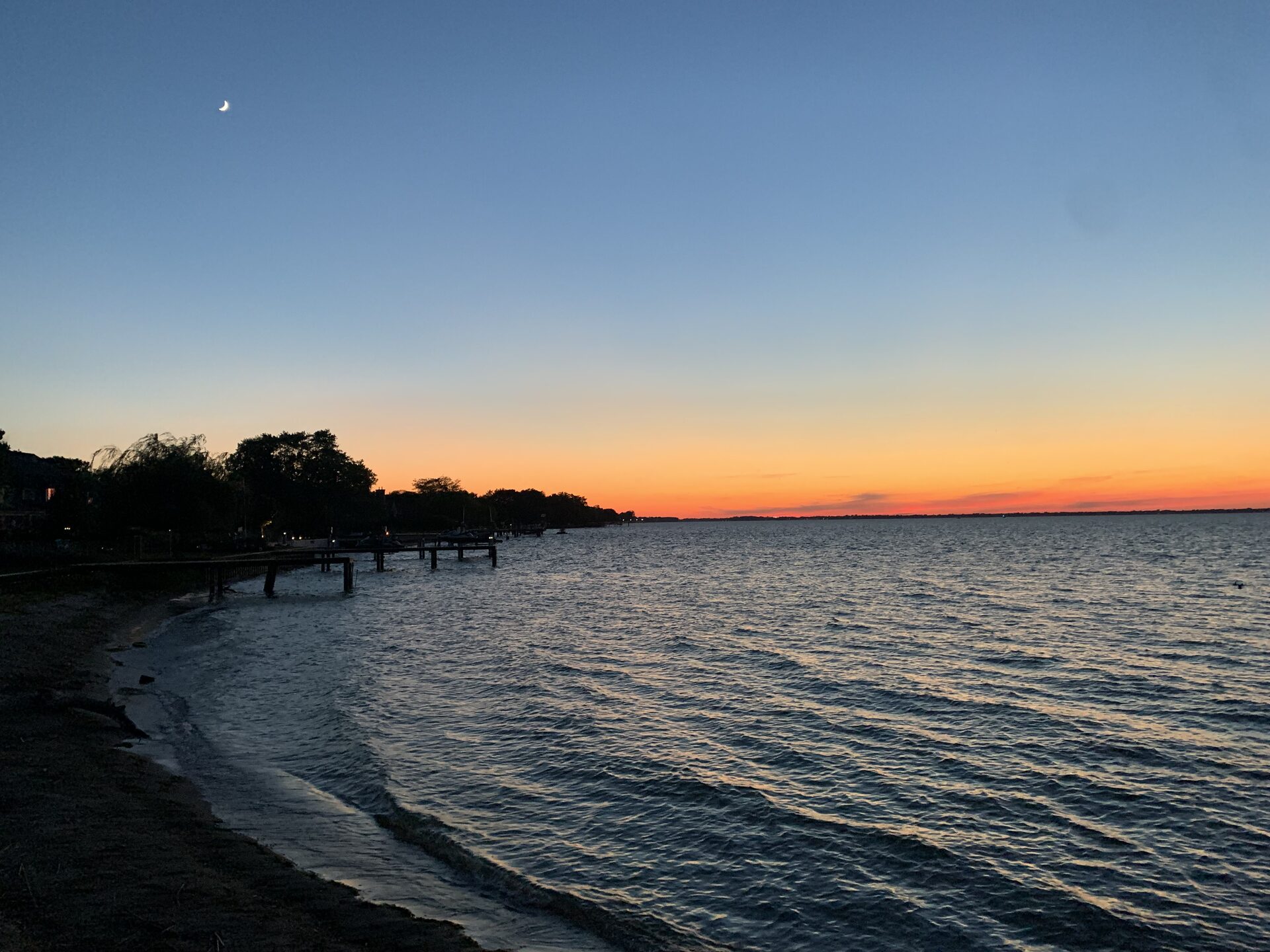 Sunset over the water at a Windsor-Essex beach