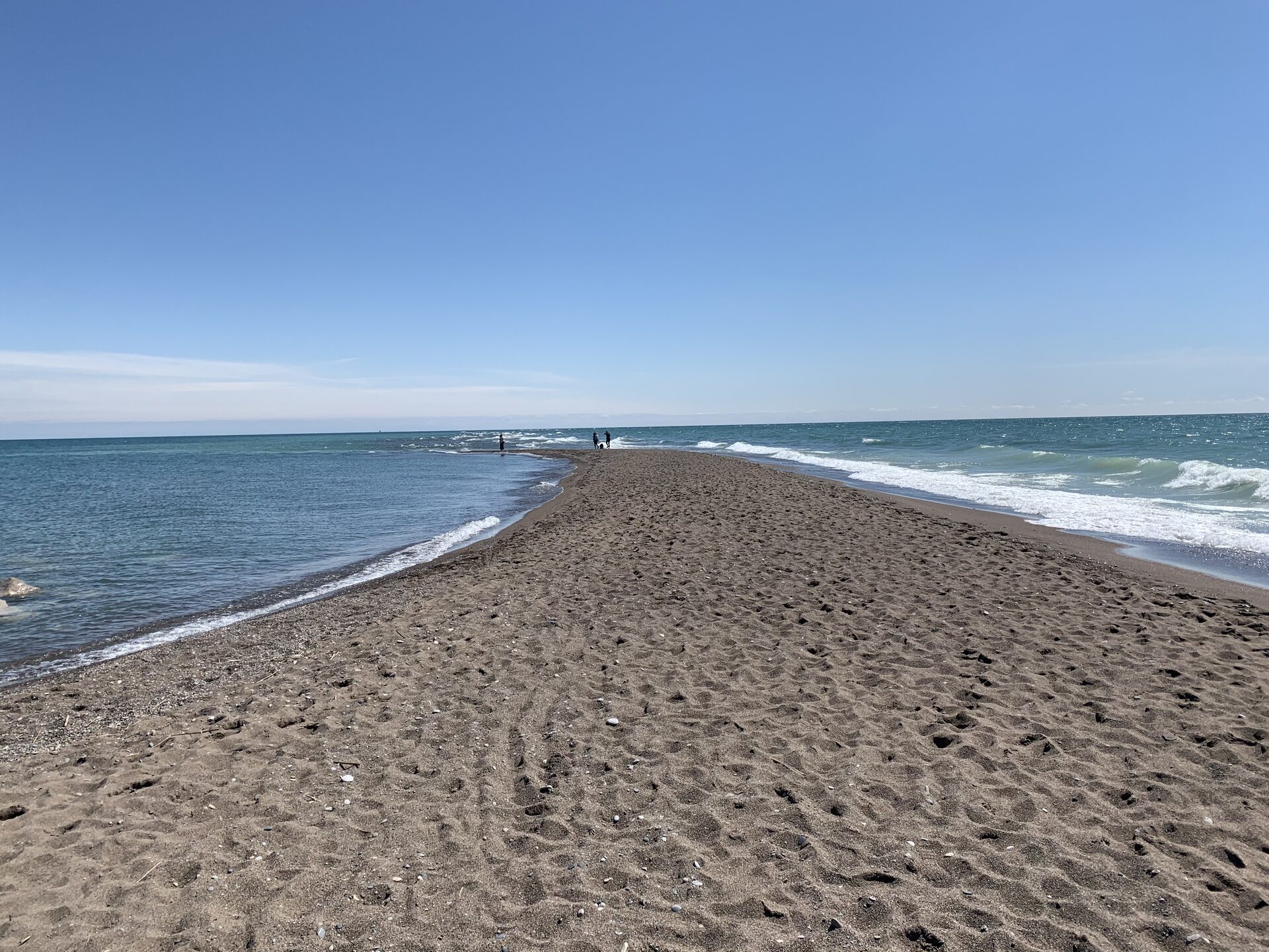 A sandy point stretching into the water at a Windsor-Essex beach